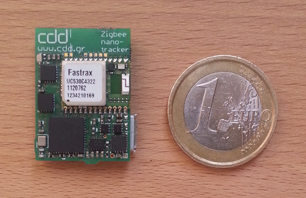 CDD miniature GPS/Zigbee tracking module next to a coin for scale
